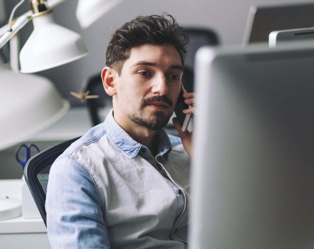 handsome businessman working in office using mobil 2021 08 26 15 54 47 utc min e1764202385638